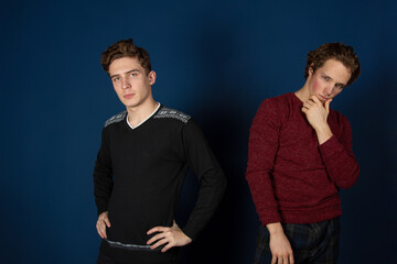 Two young attractive students are posing in the studio.