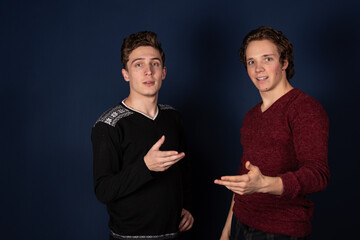 Two young attractive students are posing in the studio.