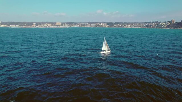 Aerial rotating shot of a single boat sailing off the coast of Pejerrey, Chile