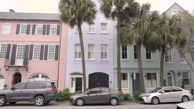 Rainbow Row Colorful Houses Street Charleston South Carolina with car driving by