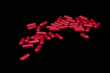 stack of red tablets isolated on a black background