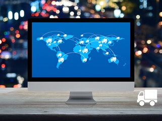 Delivery truck icon with connection line and world map on computer screen on table over night light traffic jam road, Business transportation online concept, Elements of this image furnished by NASA