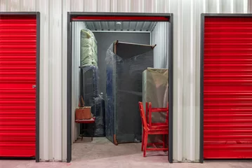 Foto op Plexiglas Corridor of self storage unit with red doors. Rental Storage Units © yalcinsonat