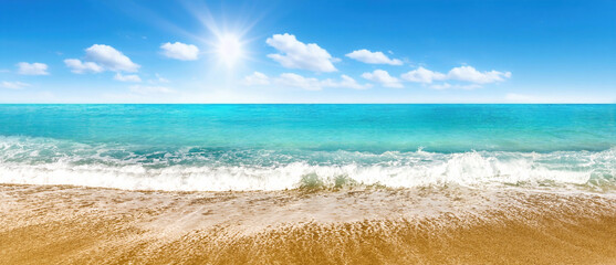 Beautiful panoramic seascape with surf waves against a blue sunny sky with clouds. Natural...
