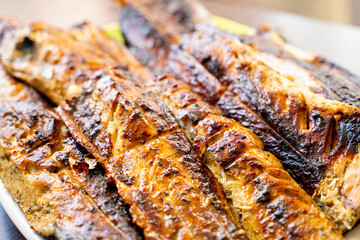 Mackerel fried on the grill, close-up. Cooked fish meat of a pleasant appetizing appearance. High-protein healthy meal for an athlete