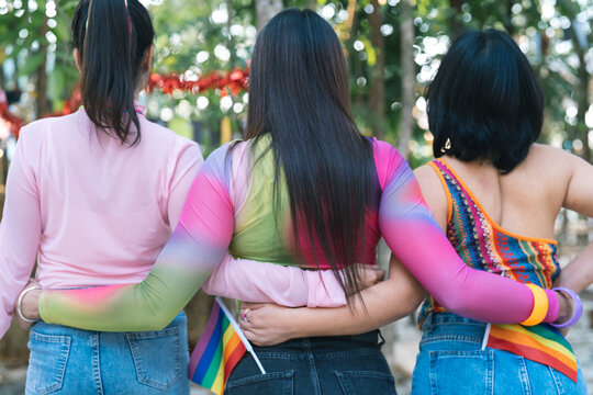 Happy friends LGBTQ transgender Asian woman LGBTQIA holding each other in summer party. friendship concept