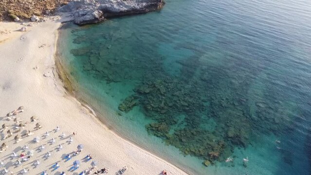 Aerial view of amazing Skinaria beach, Crete, Greece. One of many amazing beaches, places - sandy Skinaria beach with umbrellas, Plakias, Crete, Greece