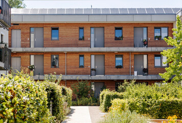 Multi-family House or Modern Apartment Building with Solar Panel, Wooden Facade and Community...