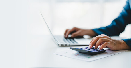 Close-up of business people working on taxes, financial accounting calculations, brokerage, copy space