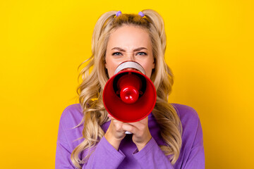 Photo portrait of attractive young woman hold shout megaphone strike dressed stylish violet outfit isolated on yellow color background