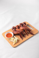 grilled bbq roasted golden honey chicken wing with spicy chilli sauce and onion on wood table asian chinese halal meat banquet snack menu for restaurant and stall