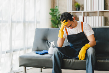 Young man tired and worried after cleaning. Stressed.