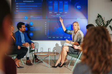 Data analyst presenting sustainability strategy to team.