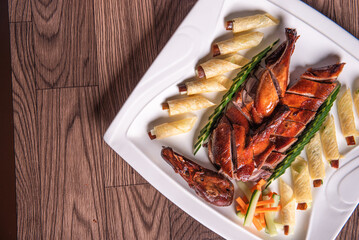 Beijing roasted whole big pipa bbq duck with crepe skin roll and vegetables on wood table background asian Chinese halal banquet meat menu 