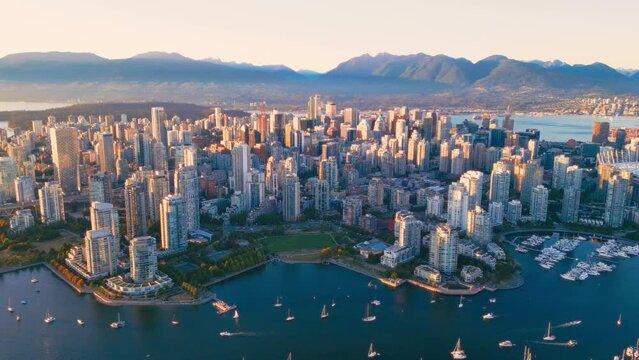 Vancouver downtown skyline aerial pullback reveal shot, BC, Canada at sunset