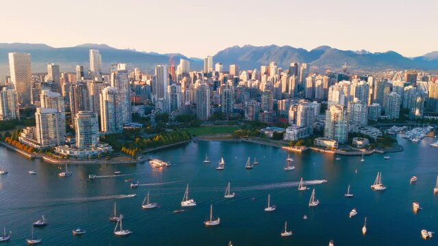 Vancouver downtown skyline aerial pullback reveal shot, BC, Canada at sunset
