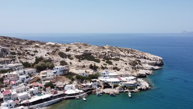Aerial drone view of famous Matala beach with caves, known for hippies in the 70's. View of the beach from rock caves, once a roman cemetery, in famous greek beach Matala, Crete, Greece.