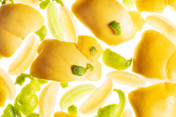 Yellow and green background with lemon, lime and peels