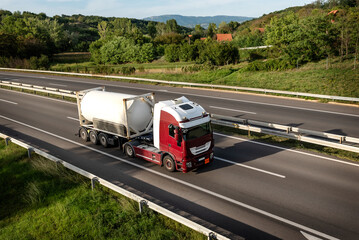 Tanker or Tank Truck on a highway road under blue sunrise sky