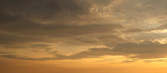 Panoramic view of sky at sunset with lots of clouds and golden light. Clear sky.