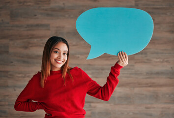 Business woman, speech bubble and smile by wall in portrait with opinion, social media mockup and workplace. Businesswoman, paper and poster for news, announcement and happy with sign, vote and voice