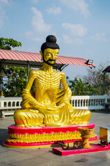 Obraz premium Buddha statue against a blue clear sky, copy space