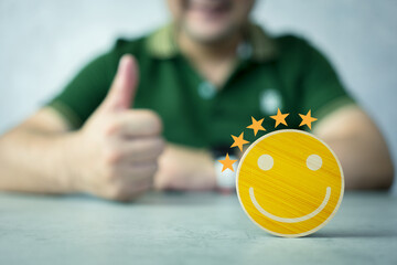 Customer services best excellent business rating experience. The customer's hand gives a smile face...