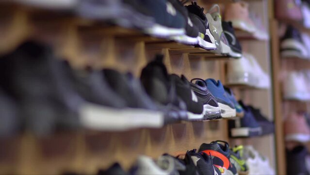 Shelves with casual shoes at store. Shallow depth of field