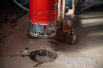 Drilling a hole into a concrete floor with core driller