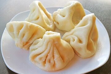 Closeup the Famous Georgian Soup Dumplings Called Khinkali on a White Plate