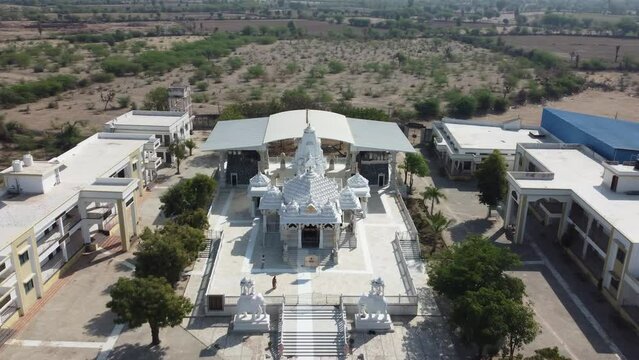 Unhel, Rajasthan, India 12th March 2023: 4k Drone shots of Shri Nageshwar Parshwanath Tirth or Shri Jain Shwetamber Nageshwar Parshwanath Tirth Pedhi is a Jain Temple. Standing Jain Murti or Idol.