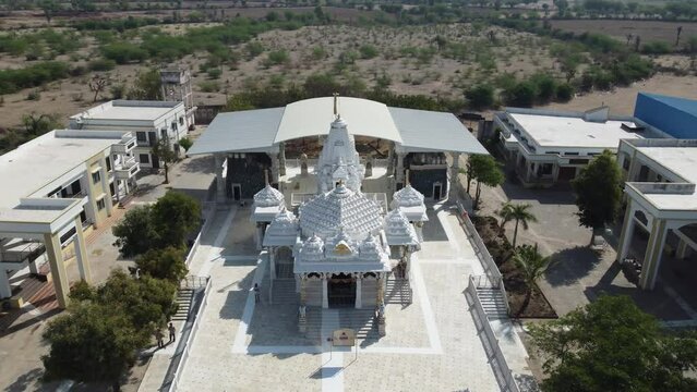 Unhel, Rajasthan, India 12th March 2023: 4k Drone shots of Shri Nageshwar Parshwanath Tirth or Shri Jain Shwetamber Nageshwar Parshwanath Tirth Pedhi is a Jain Temple. Standing Jain Murti or Idol.