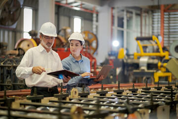 A new generation of engineers in a metal sheet factory.  Studying work methods from supervisors or...