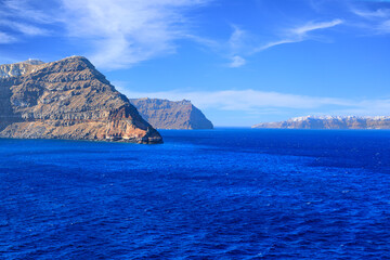 Typical coast of Santorini, member of the Cyclades group of islands in Greece. In the background the white houses of the village of Oia.
