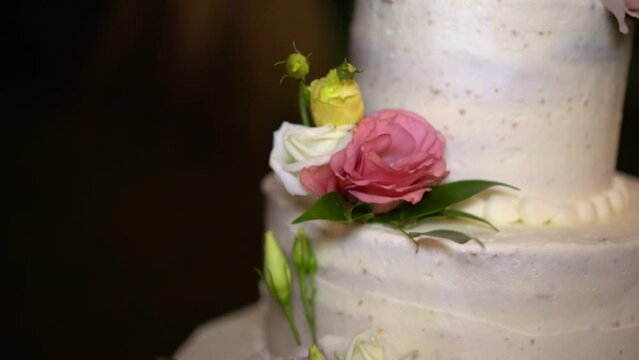 Close-up Of Wedding cake decorated with colorful roses, Tilt up shot