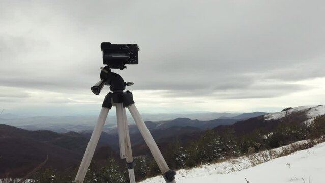 Digital professional camera stand on tripod photographing mountain, Blue sky and cloud landscape