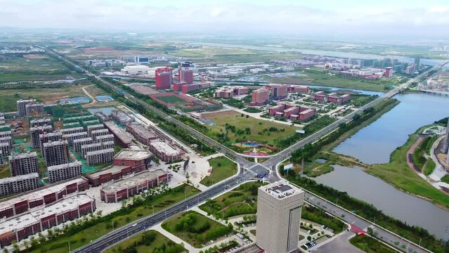 Aerial pan shot near Beijing Jiaotong University (BJTU) Weihai campus and Nanhai bus station in Nanhai new district, Shandong Province, China.
