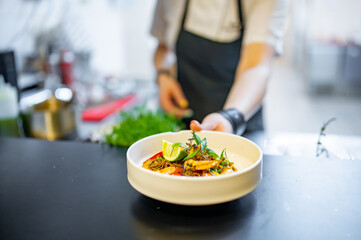 Chef cooking Stir fry noodles with vegetables and shrimps on restaurant kitchen