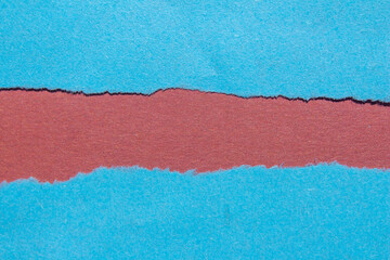Blue torn paper background with copy space for text. Ripped paper on a red background.	
