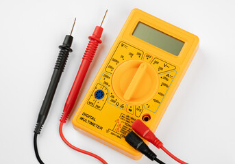 Digital multimeter with probes on a white background. 