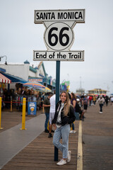 Portrait of a blonde young girl at the Santa Monica Pier celebrating the end of Route 66