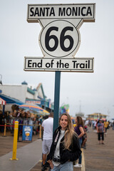 Portrait of a blonde young girl at the Santa Monica Pier celebrating the end of Route 66