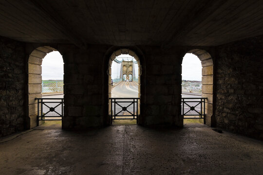 Three open-air stone arched view out onto the historic Menai Suspension Bridge & A5 traffic route, Gwynedd, North Wales