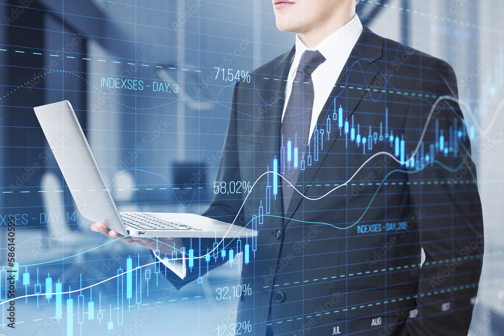 Poster close up of businessman hand using laptop computer with glowing candlestick forex chart with index o