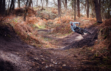 Mountain biker jumping in the forest