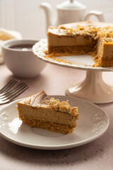 Caramel cheesecake sliced and served with cup of tea