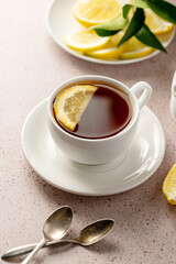 Cup of black tea and lemon slices. Slow living, drinking tea.