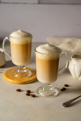 Two cups with coffee drink, latte or mocha with milk foam and cinnamon