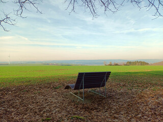 Bank vor einer Wiese mit Blick in Richtung Losheim auf dem Wanderweg Traumschleifchen Odilienweg bei Oppen in der Gemeinde Beckingen im Landkreis Merzig-Wadern, Saarland.