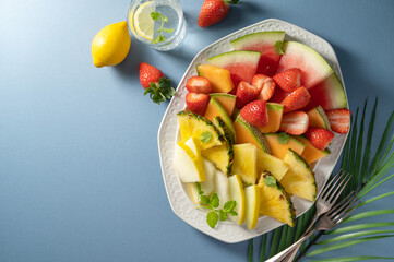 Summer fresh fruits assortment platter antipasti, watermelon, pineapple, melon and strawberries. 